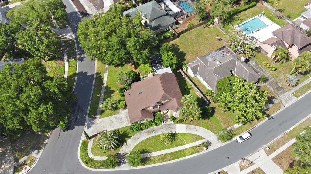 An aerial view shows a suburban house with a brown roof and a curved driveway — 2054 PALM VISTA DRIVE, APOPKA, FL