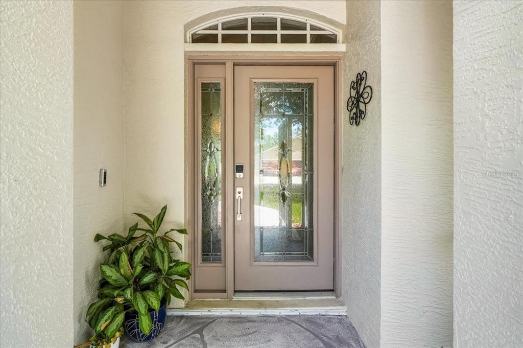 A front entryway features a light brown door with glass panels and a side light — 8905 CYPRESS PRESERVE PLACE, FORT MYERS, FL