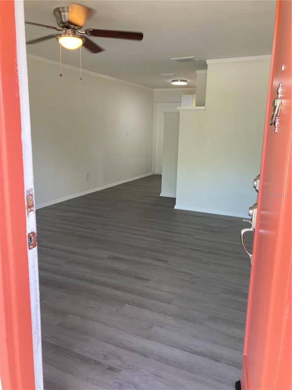 An interior view of a room with light gray wood-look flooring and a ceiling fan — 5221 N RONALD REAGAN BOULEVARD, SANFORD, FL
