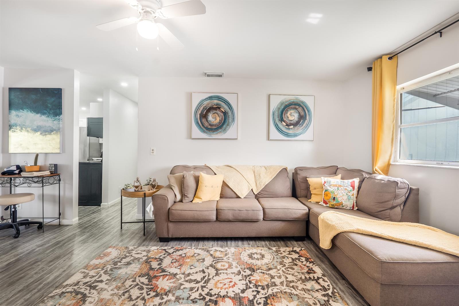 A dining area with a wooden high-top table sits adjacent to a white kitchen — 1501 SW 18th Drive, Boynton Beach FL 33426, BOYNTON BEACH, FL