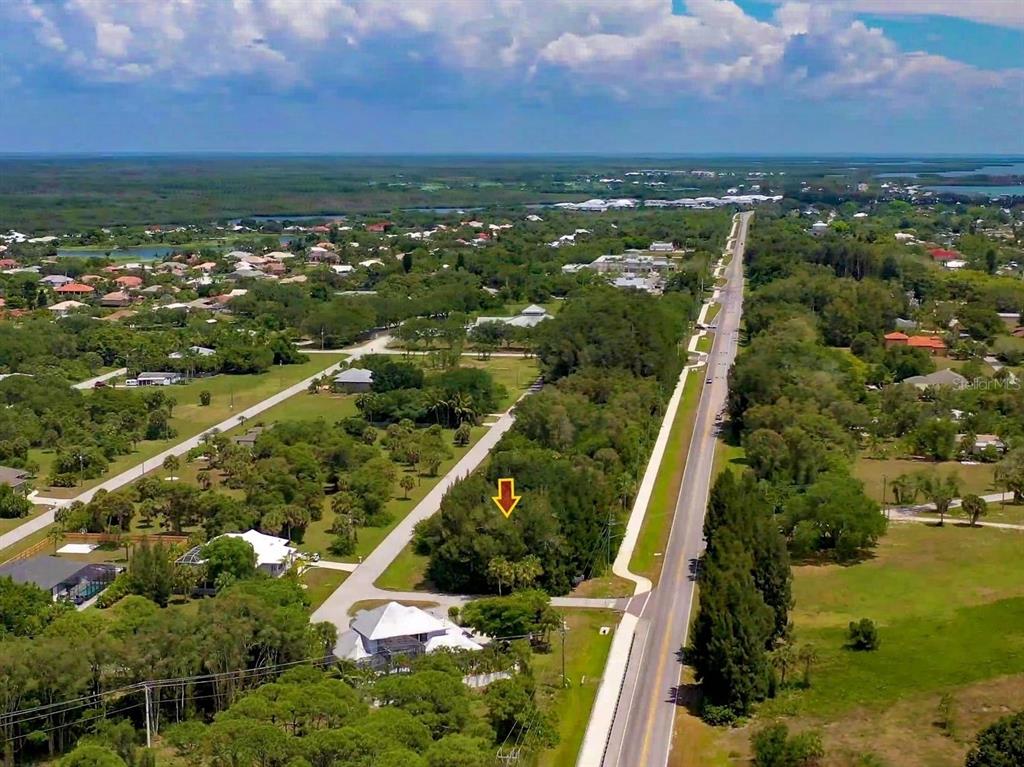 An aerial view shows a wooded lot marked by an arrow next to a road — 41 BONITA STREET, PLACIDA, FL
