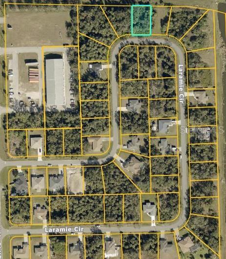 This is an aerial map showing a vacant residential lot highlighted in a suburban neighborhood — LARAMIE CIRCLE, NORTH PORT, FL