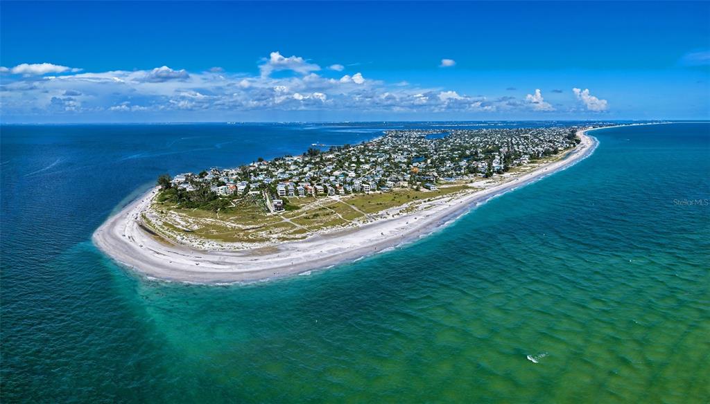 An aerial view of a coastal barrier island featuring a residential neighborhood and sandy beaches — 801 N SHORE DRIVE, ANNA MARIA, FL