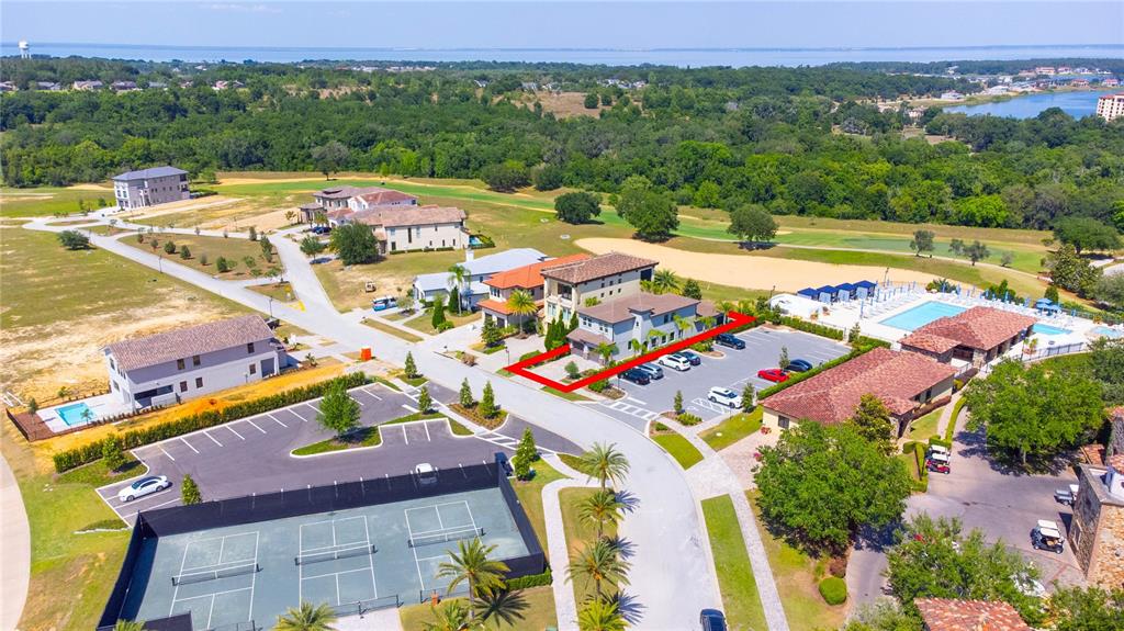 An aerial view shows a multi-story building with a red outline, parking, and tennis courts — 16210 RAVENNA COURT, MONTVERDE, FL