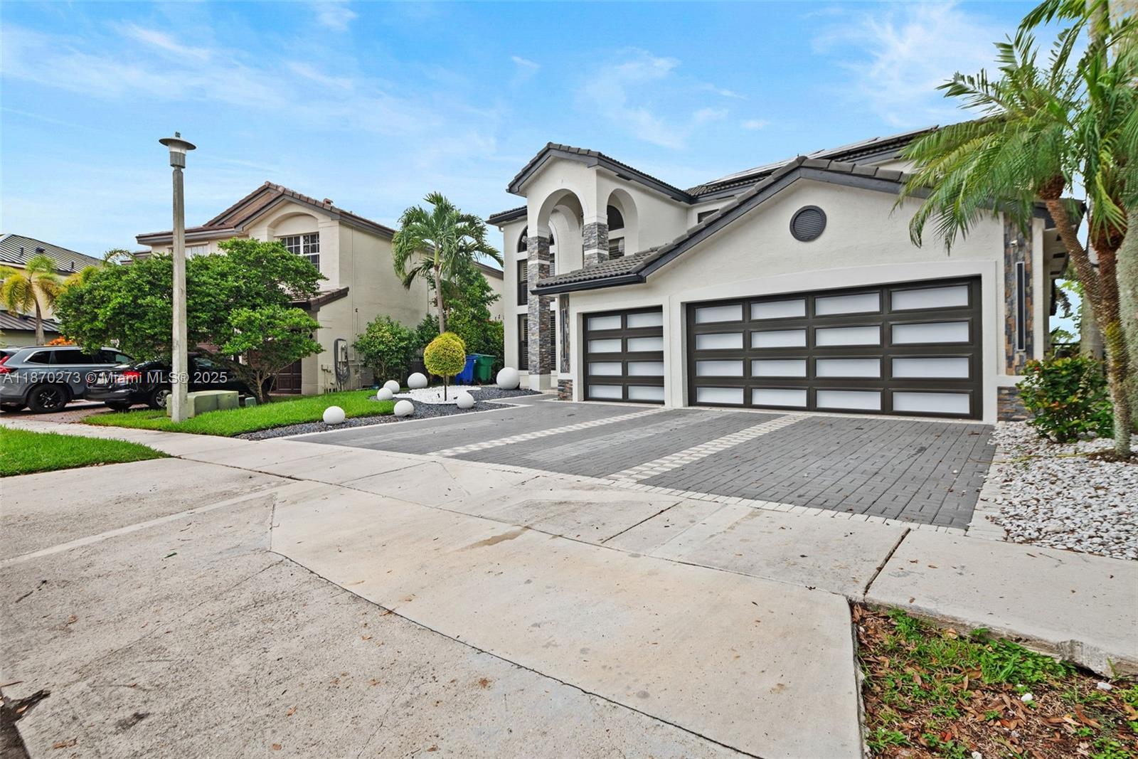 A two-story suburban house features a three-car garage, a paved driveway, and palm trees — 3591 SW 177th Ave, Miramar FL 33029, MIRAMAR, FL