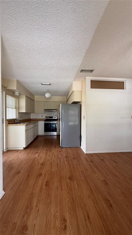 A kitchen with light-colored cabinets, stainless steel appliances, and wood-look flooring — 201 SAN MARCO AVENUE UNIT 2, NORTH PORT, FL