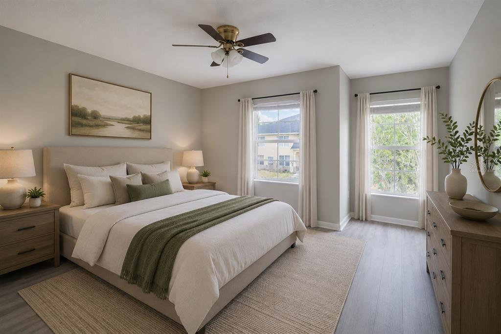 A bedroom with a bed, two nightstands, a dresser, and two windows with curtains — 10956 BRICKSIDE COURT, RIVERVIEW, FL