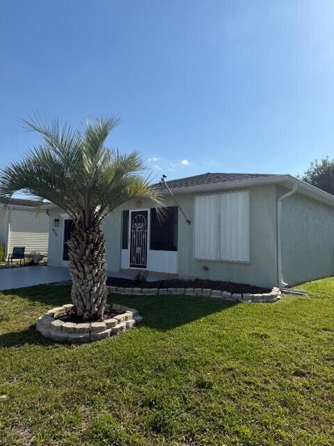 A single-story house with a palm tree in the front yard and storm shutters — 6715 Mar Pacifico, Fort Pierce FL 34951, FORT PIERCE, FL