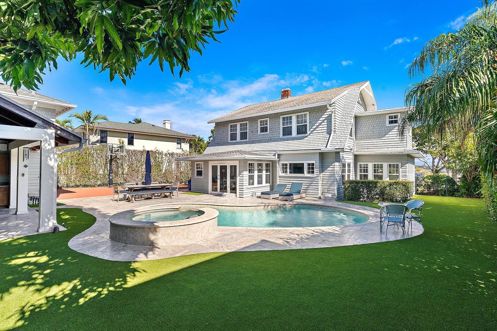 A two-story gray shingled house features a backyard pool, hot tub, and artificial grass lawn — 3109 Washington Road, West Palm Beach FL 33405, WEST PALM BEACH, FL