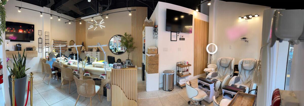 A panoramic view of a nail salon featuring manicure stations, pedicure chairs, and modern decor — 50 Biscayne Boulevard, Miami FL 33132, MIAMI, FL