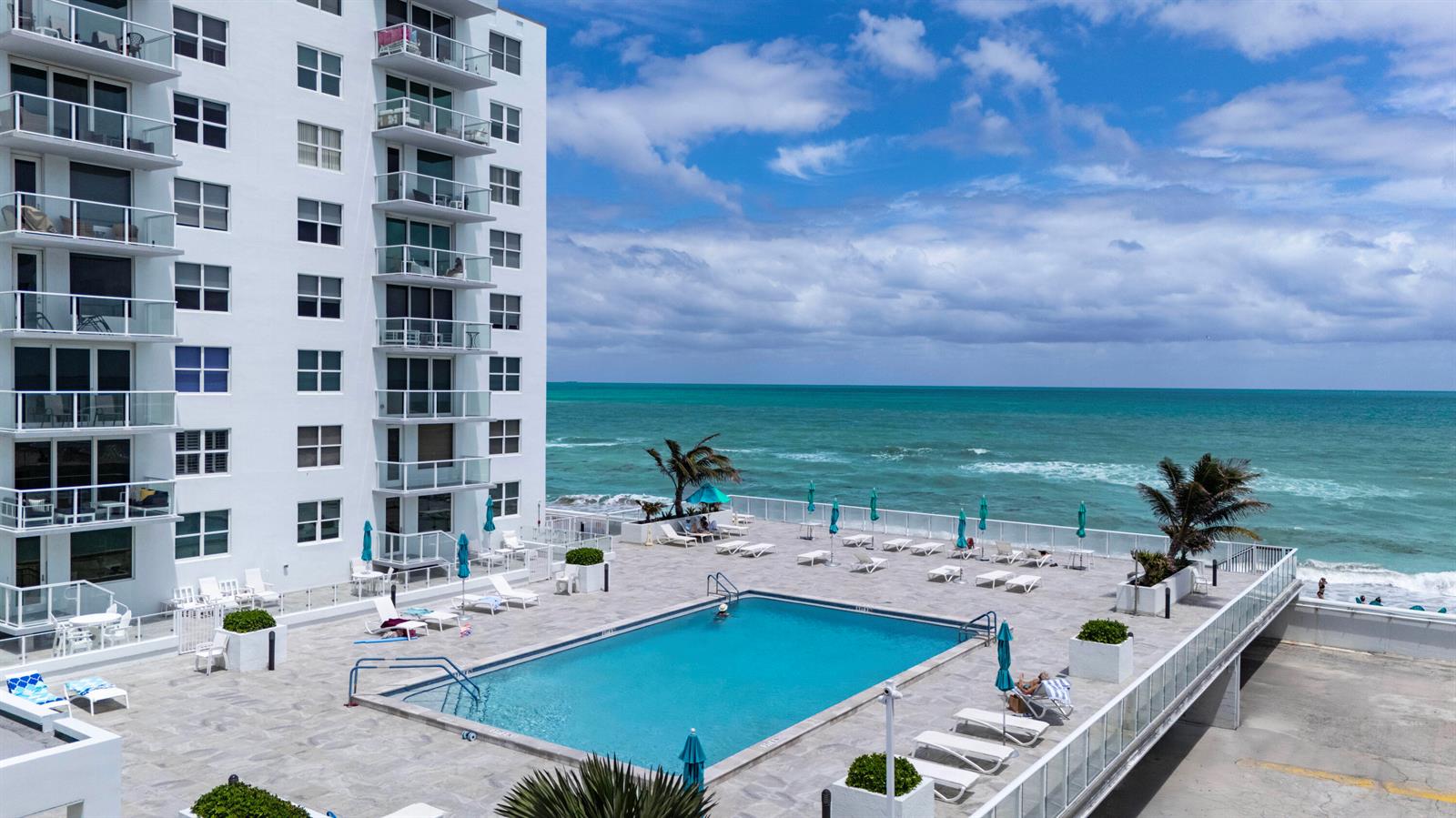 An aerial view shows a white multi-story apartment building with a parking lot and landscaping — 3450 S Ocean Boulevard # 316, Palm Beach FL 33480, PALM BEACH, FL
