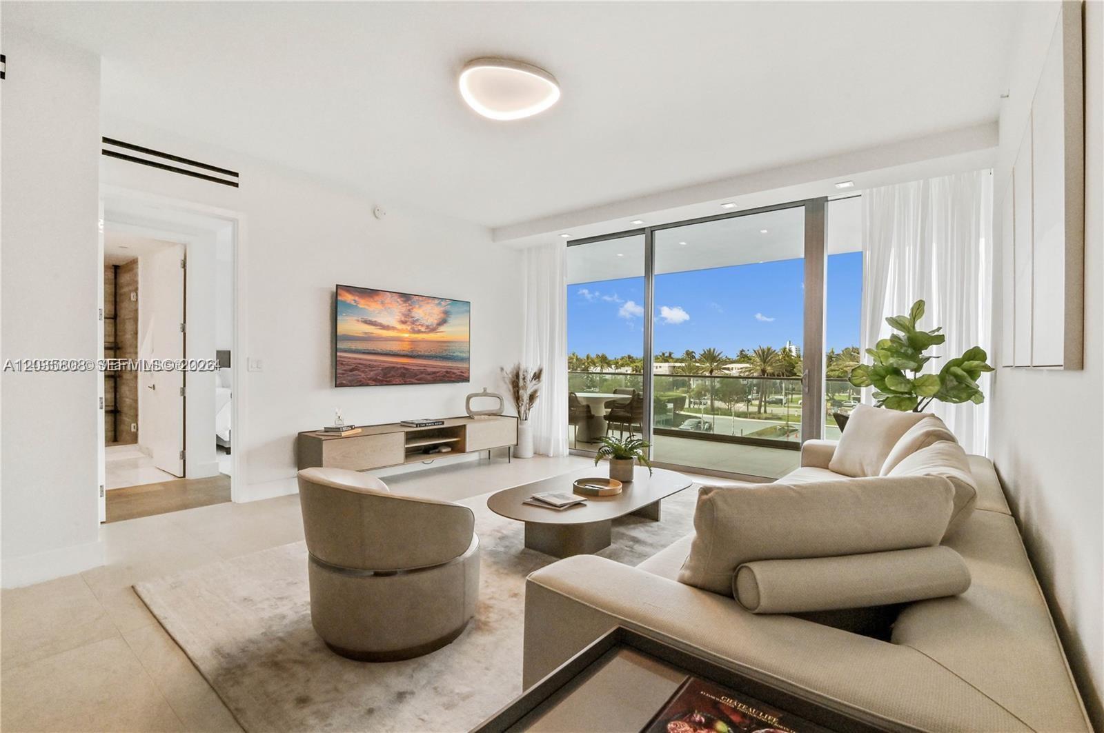 A modern living room features a sofa, accent chair, coffee table, and a balcony view — 10203 Collins Ave # 305, Bal Harbour FL 33154, BAL HARBOUR, FL