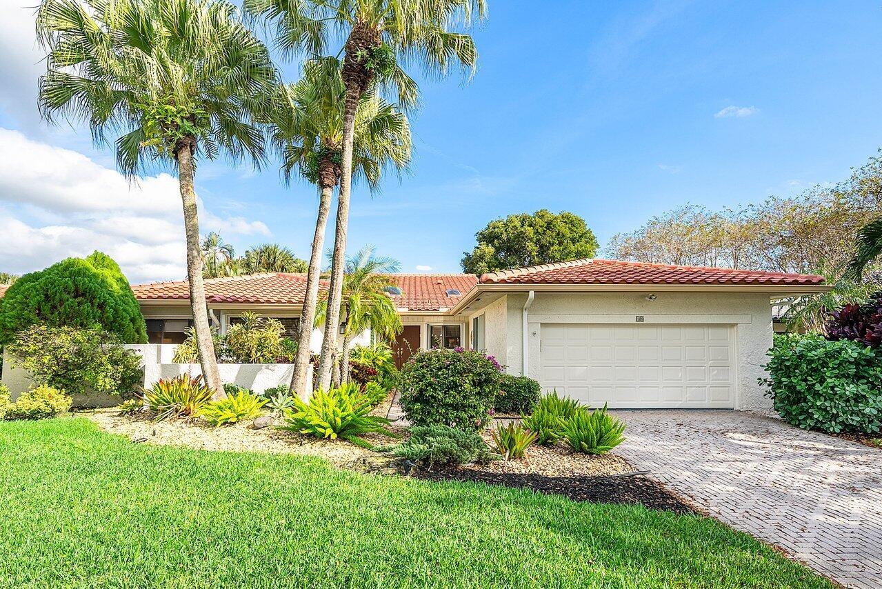 A single-story house with a white garage, tile roof, and palm trees in the front yard — 18 Bristol Lane, Boynton Beach FL 33436, BOYNTON BEACH, FL