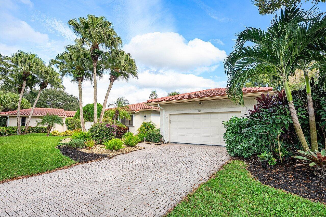 A single-story house with a tiled roof, a two-car garage, and a paved driveway — 18 Bristol Lane, Boynton Beach FL 33436, BOYNTON BEACH, FL