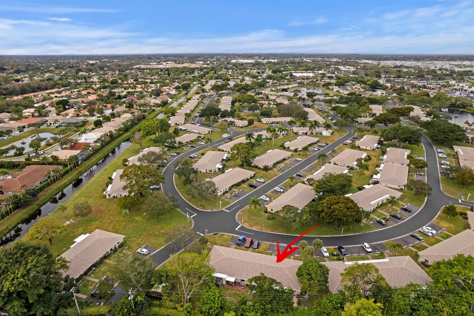 An aerial view shows a residential neighborhood with single-story buildings and a red arrow pointing down — 8555 Bella Vista Drive # 86, Boca Raton FL 33433, BOCA RATON, FL