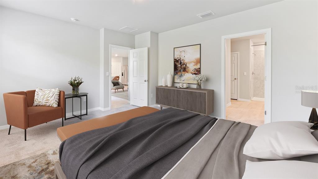 A bedroom features a bed, an armchair, a console table, and an attached bathroom — 16313 JUAREZ CIRCLE, PUNTA GORDA, FL