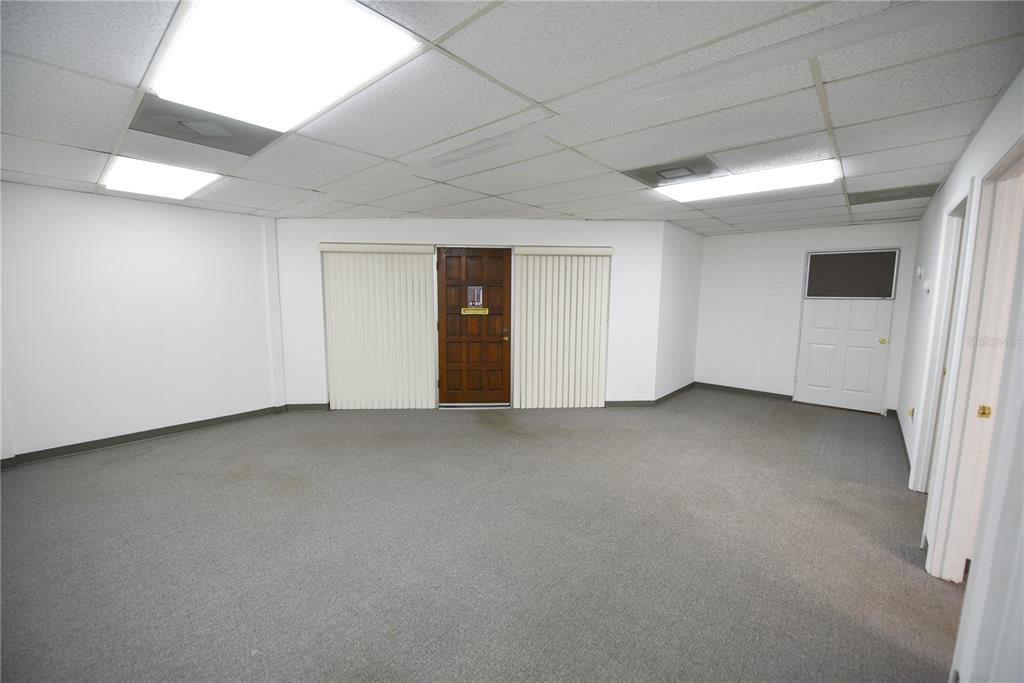 An empty office space with gray carpet, white walls, and a drop ceiling with lights — 1200 N CENTRAL AVENUE UNIT 210, KISSIMMEE, FL