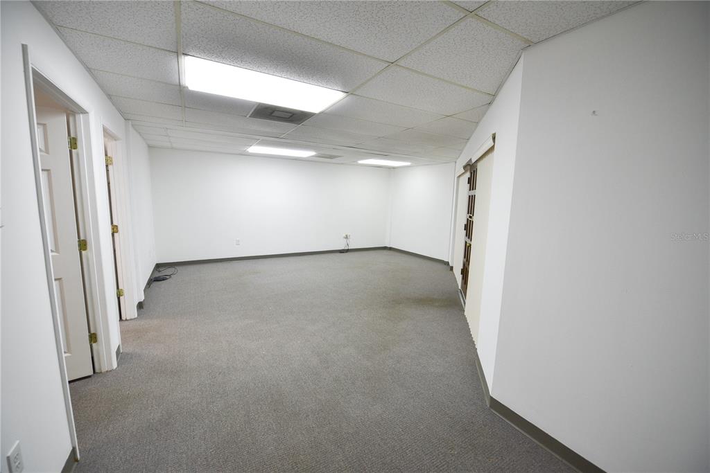 An empty office room with white walls, gray carpet, and a drop ceiling — 1200 N CENTRAL AVENUE UNIT 210, KISSIMMEE, FL