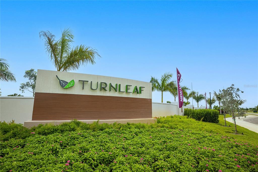 A large monument sign for the Turnleaf community stands in a landscaped area — 13314 GRASSMERE COURT, PUNTA GORDA, FL