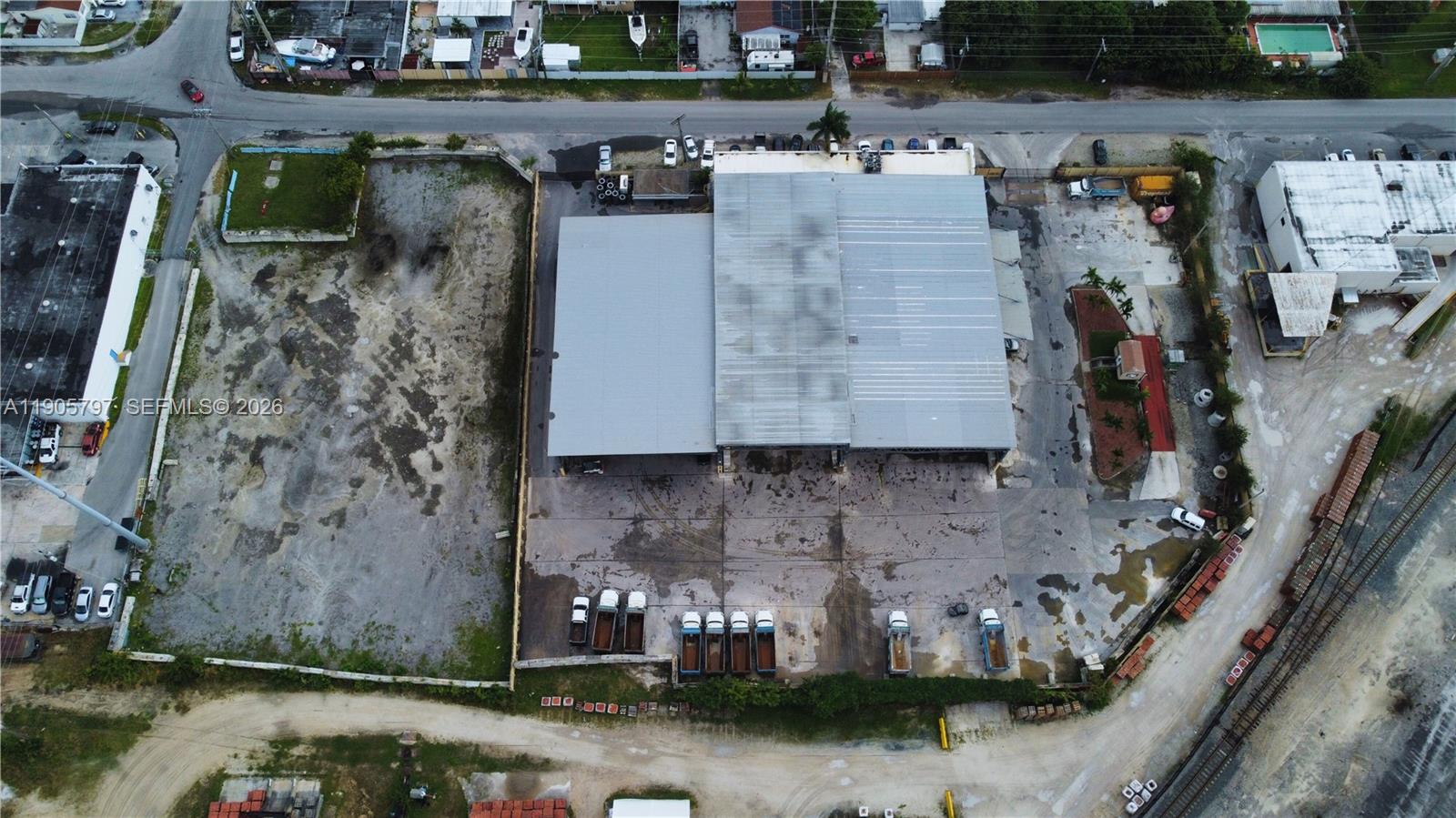 An aerial view shows a commercial warehouse building with a large paved parking lot — 8650 NW 36 Ave, Miami FL 33147, MIAMI, FL