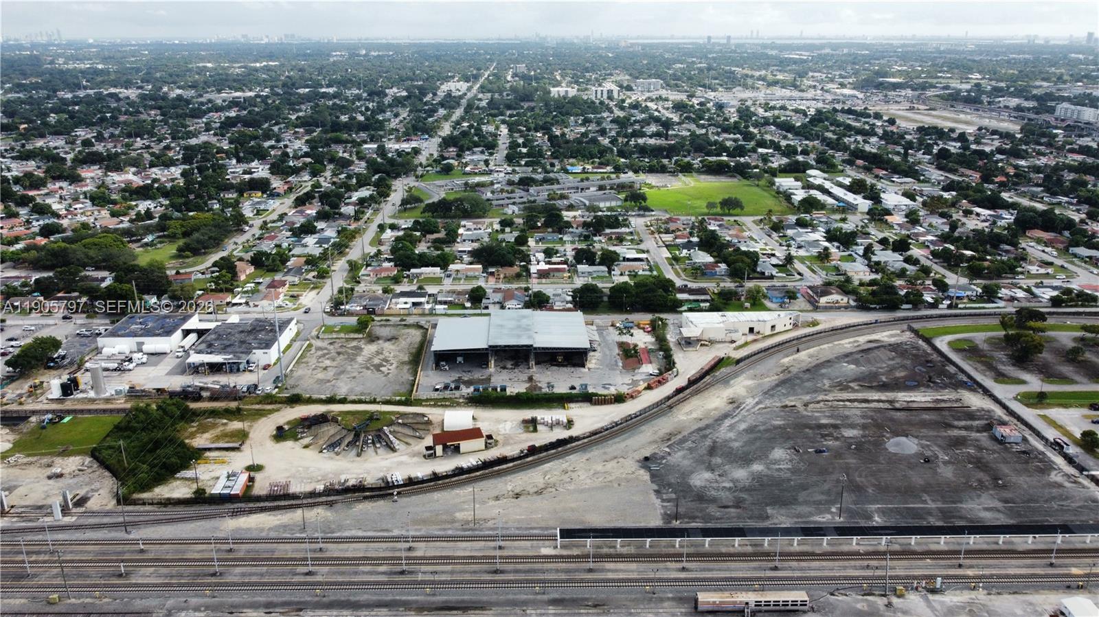An aerial view shows industrial buildings, a railway line, and surrounding residential neighborhoods — 8650 NW 36 Ave, Miami FL 33147, MIAMI, FL