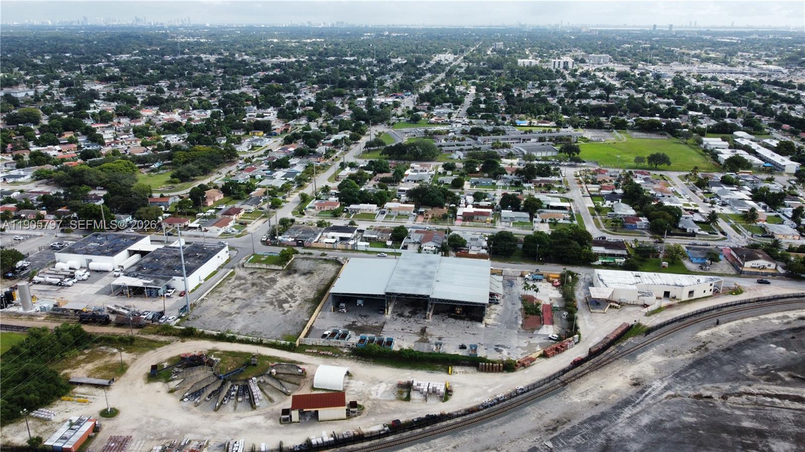 An aerial view shows a commercial warehouse facility with a large parking lot and railroad tracks — 8650 NW 36 Ave, Miami FL 33147, MIAMI, FL