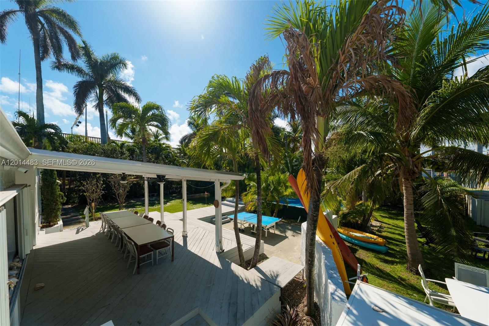 A backyard patio features a covered dining area, a ping pong table, and palm trees — 701 Hollywood Blvd, Hollywood FL 33019, HOLLYWOOD, FL