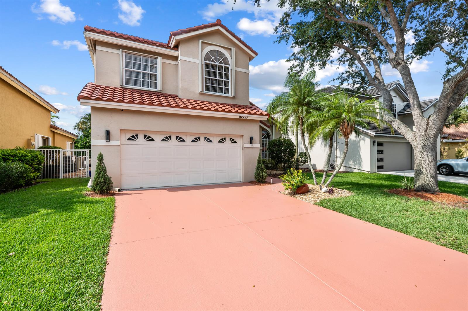 A two-story house with a red tile roof, a two-car garage, and a pink driveway — 10927 La Salinas Circle, Boca Raton FL 33428, BOCA RATON, FL