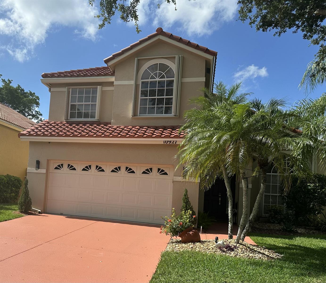 A two-story house with a tan stucco exterior, red tile roof, and a two-car garage — 10927 La Salinas Circle, Boca Raton FL 33428, BOCA RATON, FL