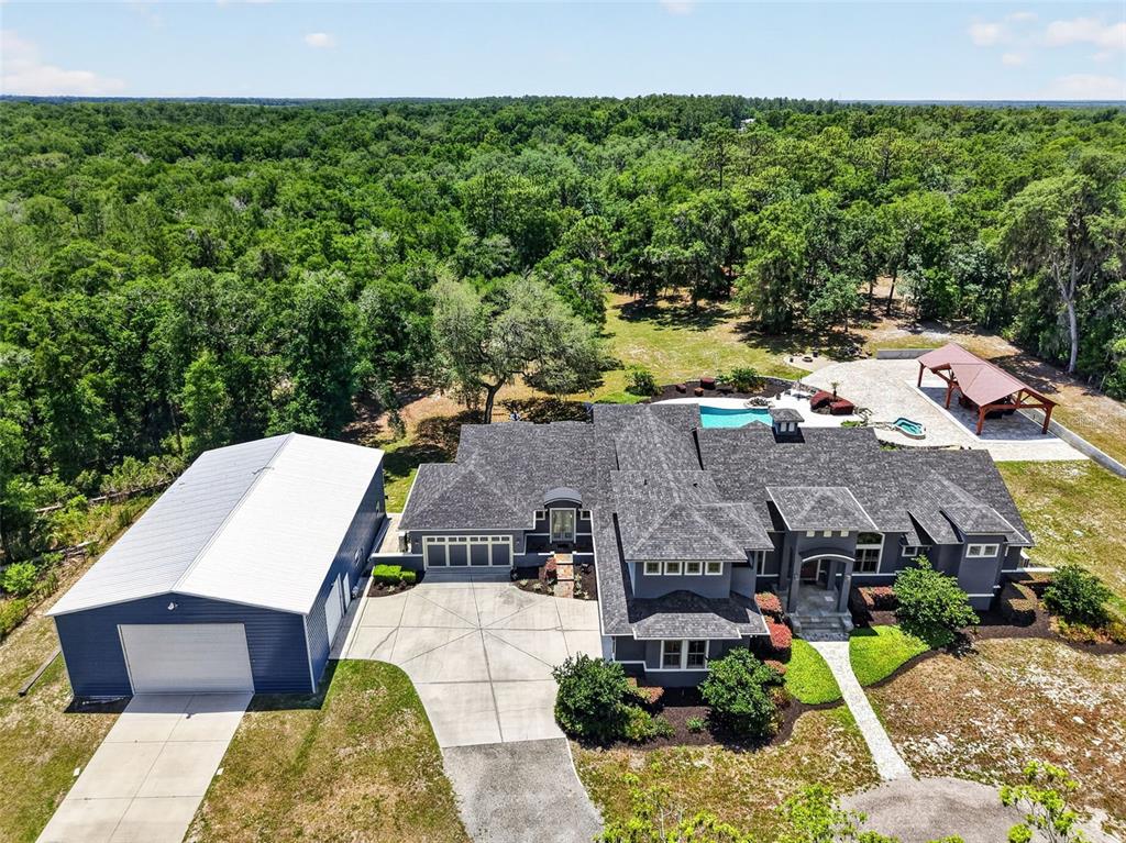 An aerial view shows a large house with a detached garage, pool, and gazebo — 2110 HIGHLAND PARK ROAD, DELAND, FL