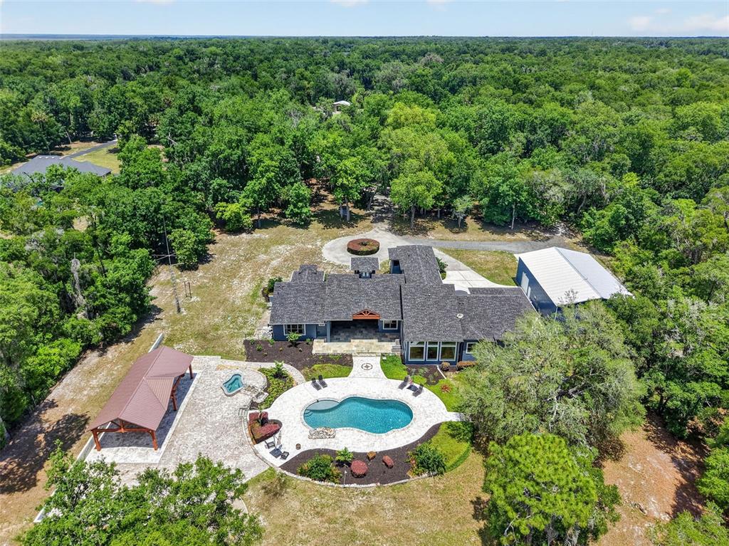 A blue house with a stone walkway leading to a double front door entrance — 2110 HIGHLAND PARK ROAD, DELAND, FL