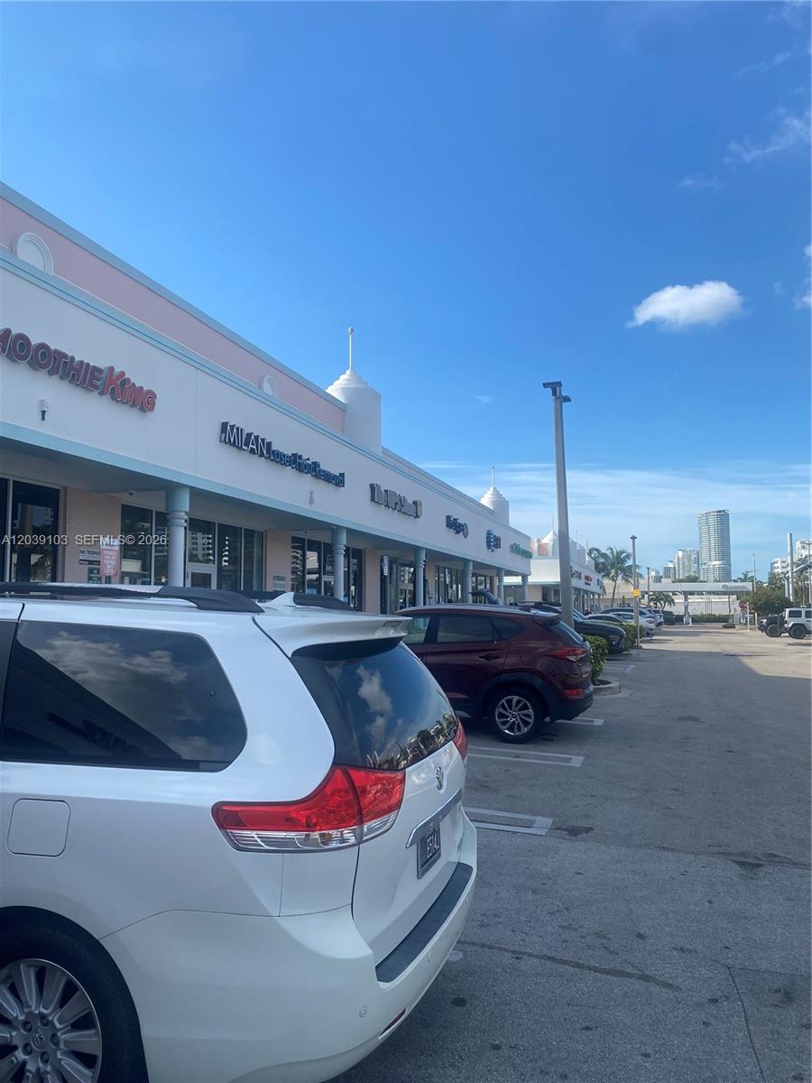 A parking lot sits in front of a strip mall featuring a Smoothie King — 1527 Alton Rd, Miami Beach FL 33139, MIAMI BEACH, FL