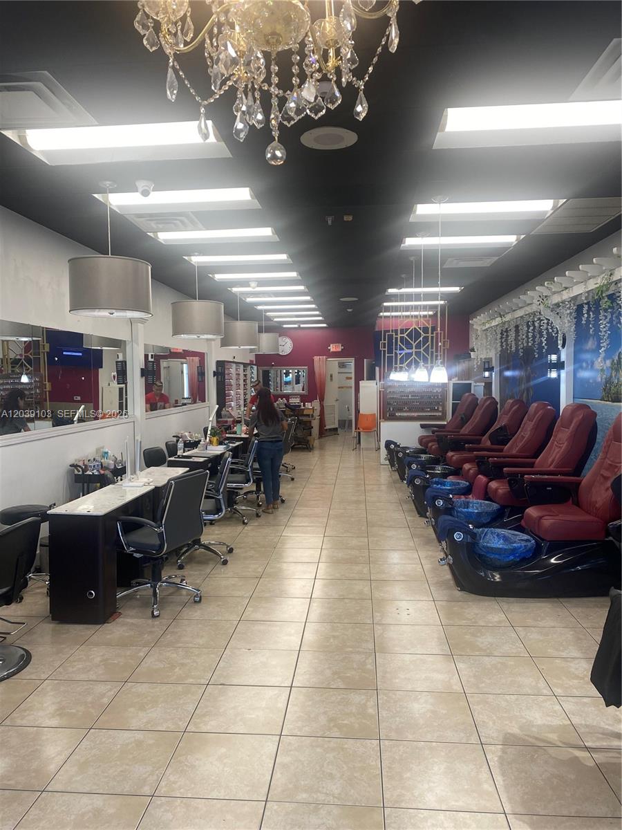 A nail salon interior features rows of manicure stations, pedicure chairs, and a crystal chandelier — 1527 Alton Rd, Miami Beach FL 33139, MIAMI BEACH, FL