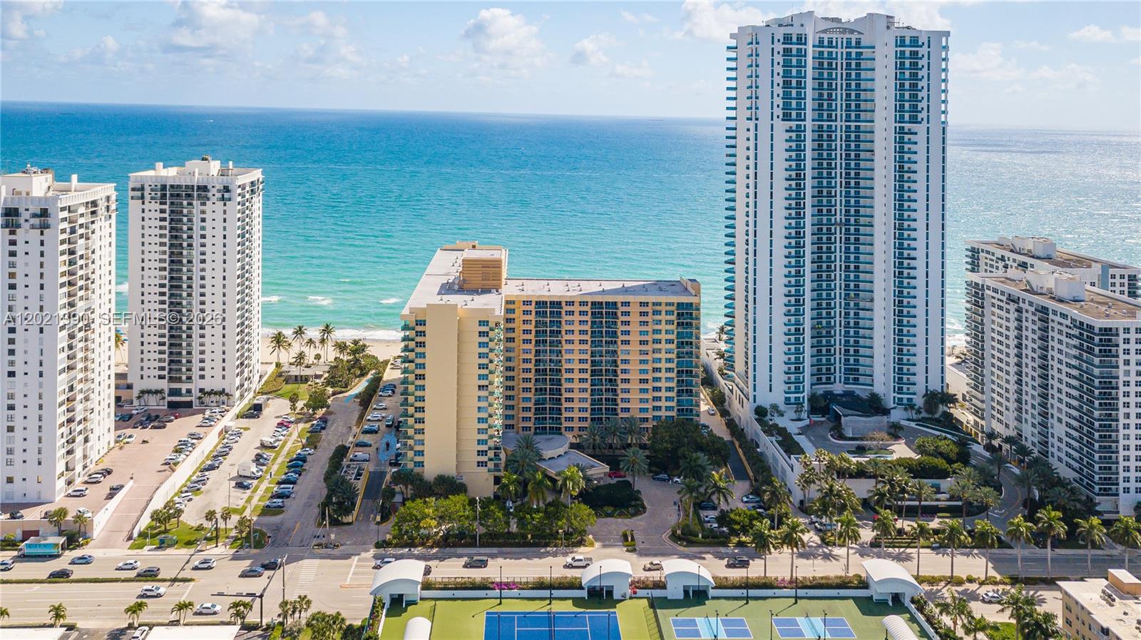 An aerial view shows several high-rise residential buildings situated along a sandy beach — 2501 S Ocean Dr # 1603, Hollywood FL 33019, HOLLYWOOD, FL