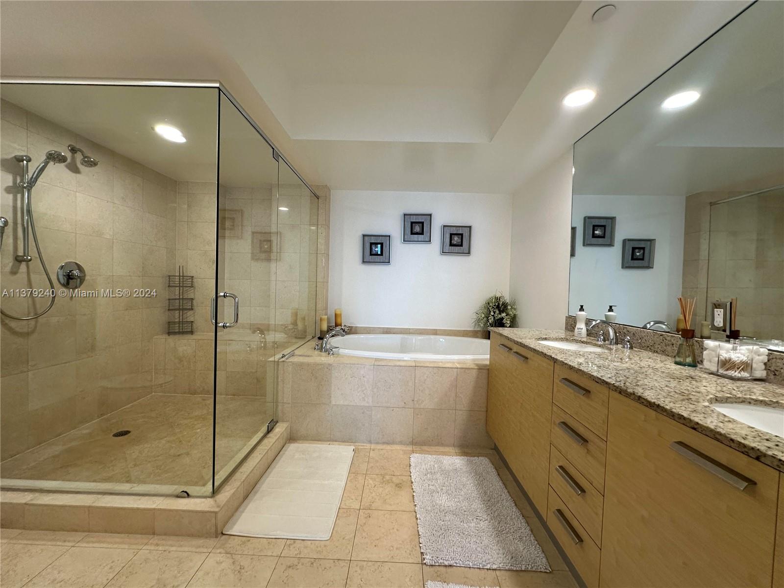 A bathroom features a glass-enclosed shower, a soaking tub, and a double vanity with granite — 1830 S Ocean Dr # 2010, Hallandale Beach FL 33009, HALLANDALE BEACH, FL