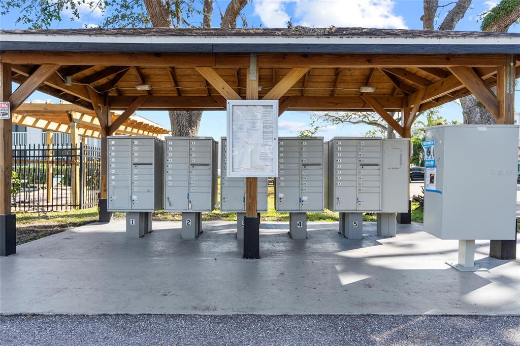 A covered outdoor structure houses several rows of metal mailboxes on a concrete pad — 5310 26TH STREET W UNIT 304, BRADENTON, FL