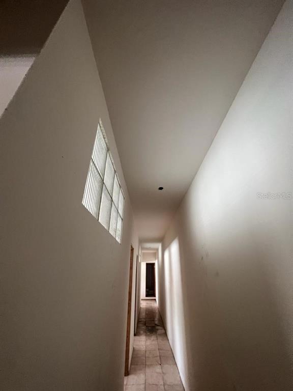 A narrow hallway with white walls, tiled flooring, and a glass block window — 708 Ave  Fernandez Juncos MIRAMAR, SAN JUAN, PR