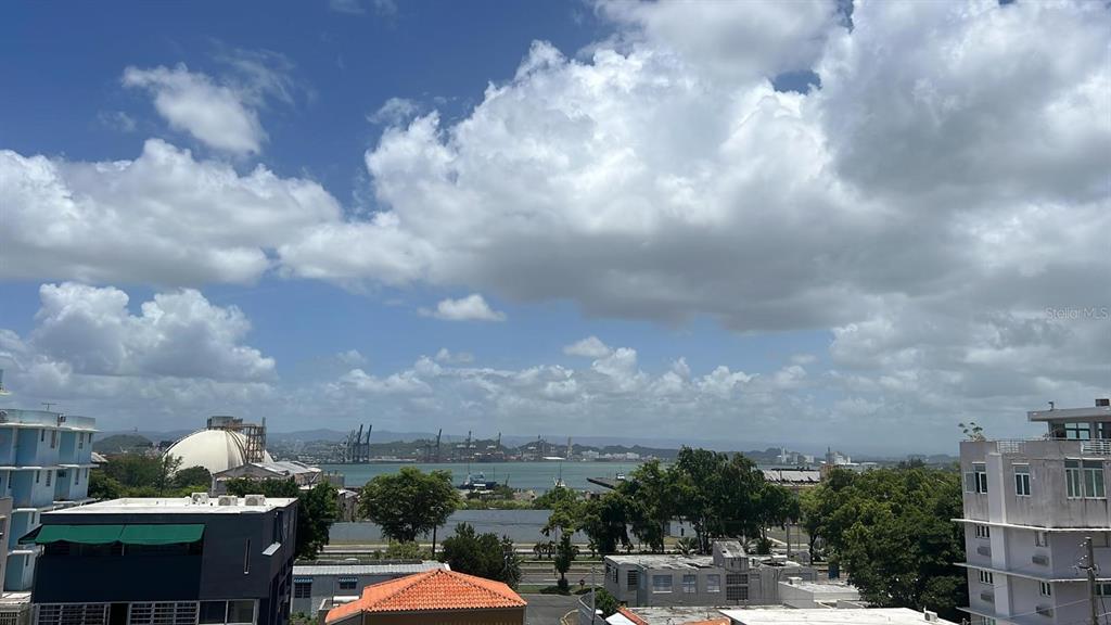 An elevated view shows a harbor with cranes, buildings, and a cloudy blue sky — 708 Ave  Fernandez Juncos MIRAMAR, SAN JUAN, PR