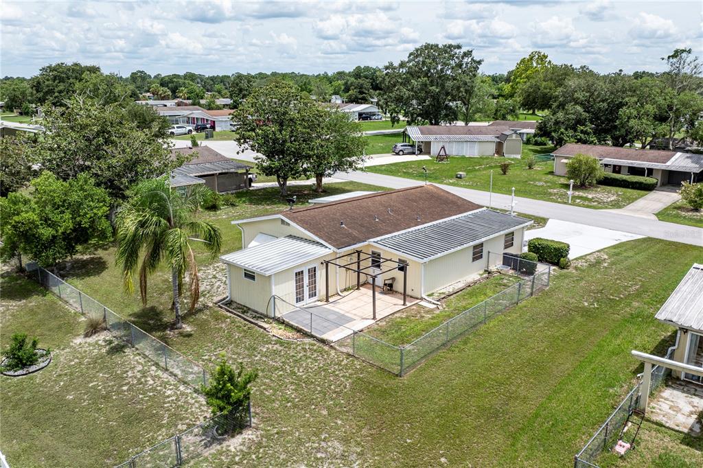 An aerial view of a single-story house with a fenced backyard and a patio — 9035 SW 102ND PLACE, OCALA, FL