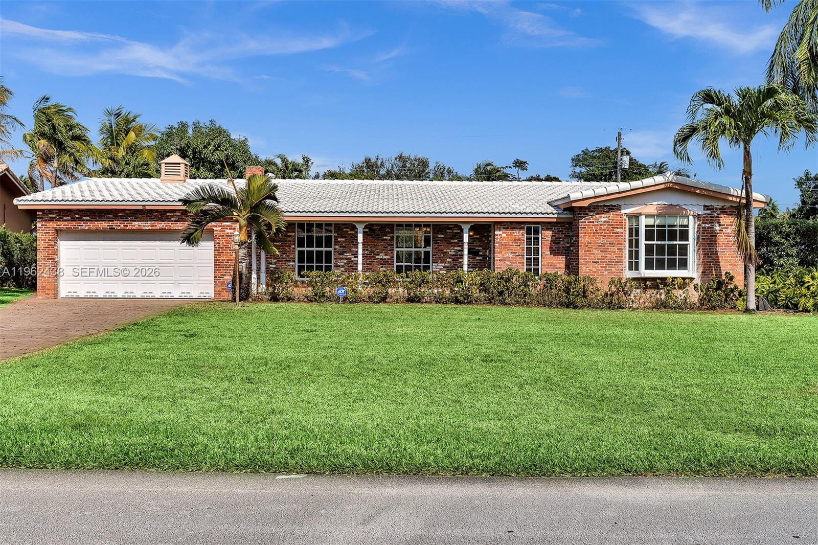 A single-story brick house with a white tile roof and a large front lawn — 3437 Buchanan St, Hollywood FL 33021, HOLLYWOOD, FL