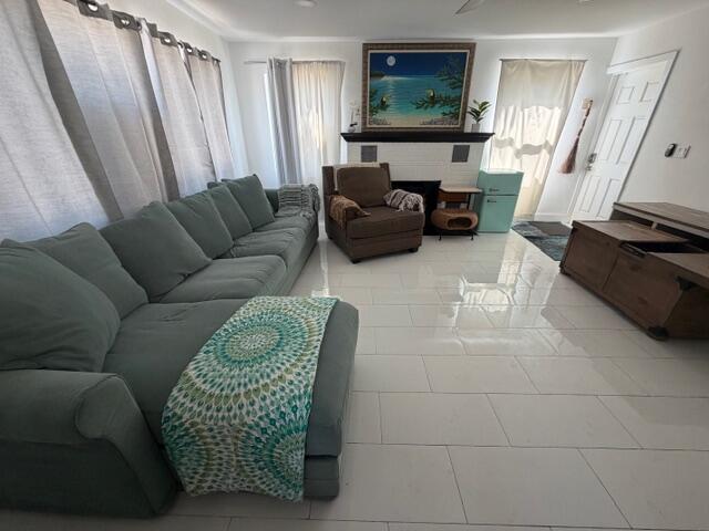 A living room features a large sectional sofa, a brown armchair, and white tile flooring — 1015 S K Street, FL 33460, FL