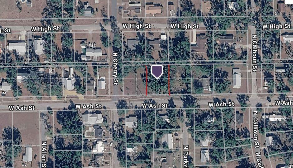 An aerial map view shows a vacant rectangular lot outlined in red on a city block — 400 W ASH STREET, PERRY, FL