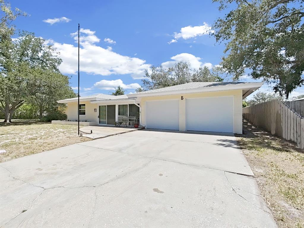 A single-story house with a two-car garage, a concrete driveway, and a patio area — 5 N KEYSTONE DRIVE, CLEARWATER, FL