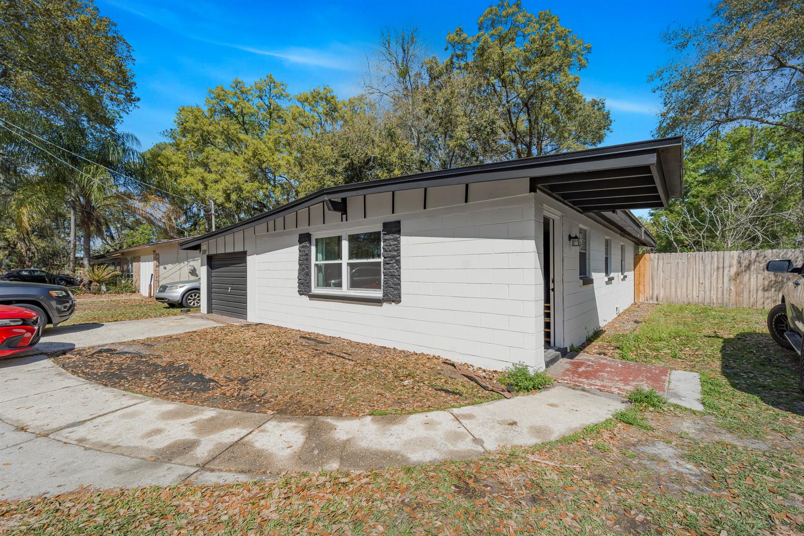 A white concrete block house with a black trim roof and a small front yard — 3105 Loretto Road, Jacksonville FL 32223, JACKSONVILLE, FL
