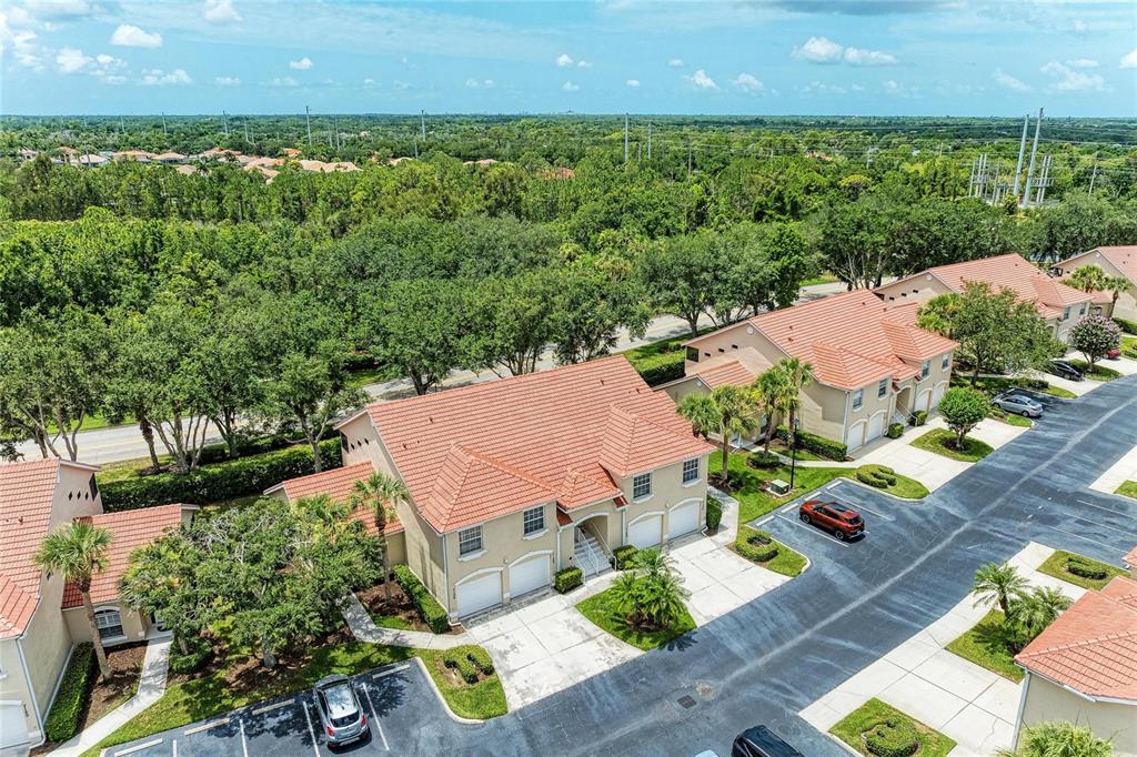 An aerial view of a multi-unit residential building with red tile roofs and driveways — 7126 CEDAR HOLLOW CIRCLE, BRADENTON, FL
