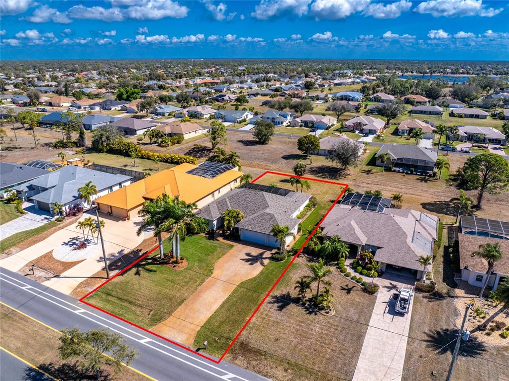 An aerial view shows a single-story house with a red outline highlighting its property lot — 250 ROTONDA BOULEVARD N, ROTONDA WEST, FL