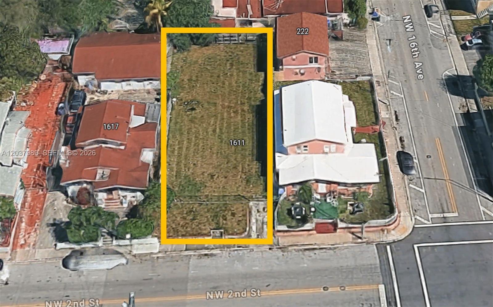An aerial view shows a rectangular vacant lot situated between two residential properties — 1611 NW 2nd St, Miami FL 33125, MIAMI, FL