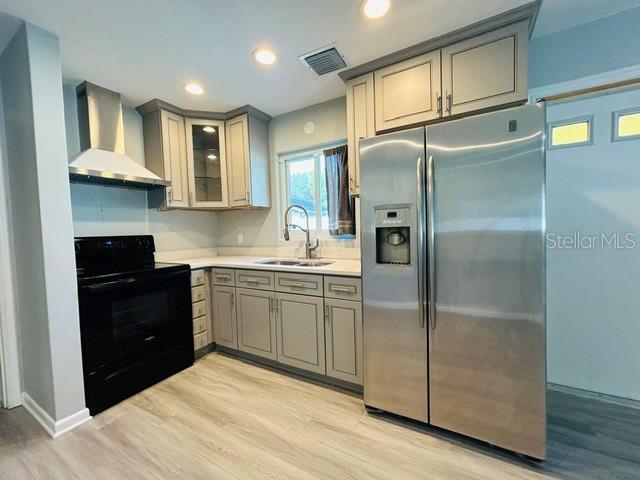 A kitchen featuring light gray cabinetry, stainless steel appliances, and wood-look flooring — 1914 CHAMBERLIN STREET, ORLANDO, FL