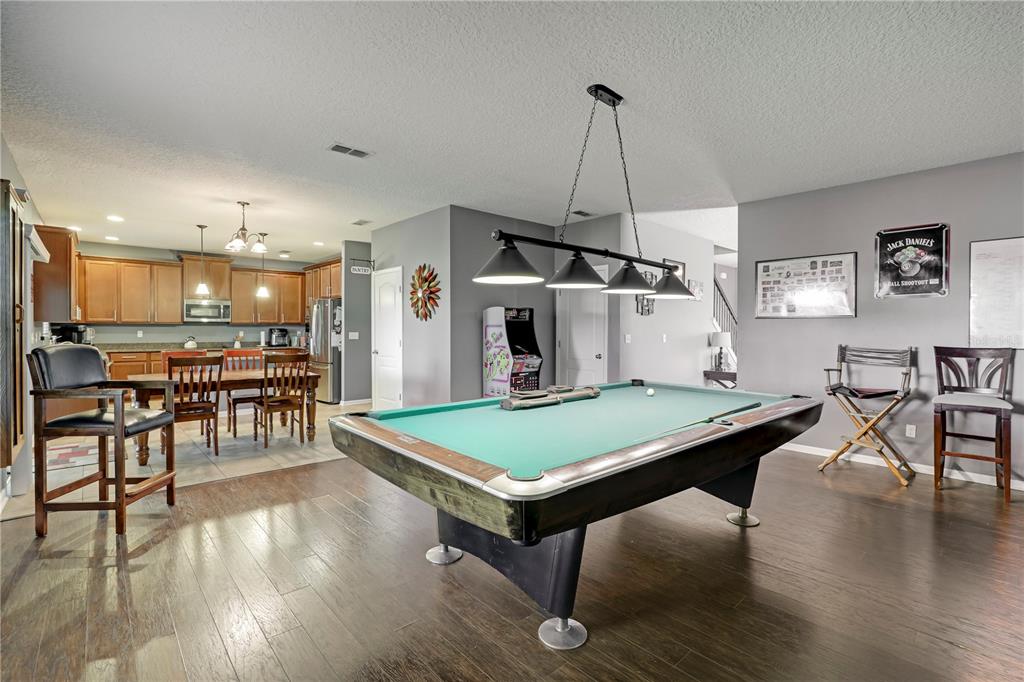 A kitchen with wood cabinets, granite countertops, stainless steel appliances, and a central island — 3520 OGLEBAY DRIVE, GREEN COVE SPRINGS, FL