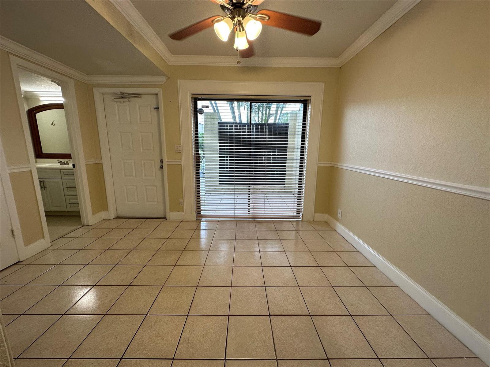 A tiled dining area features a ceiling fan, a white door, and sliding glass doors — 22435 SW 61st Way # 124, Boca Raton FL 33428, BOCA RATON, FL